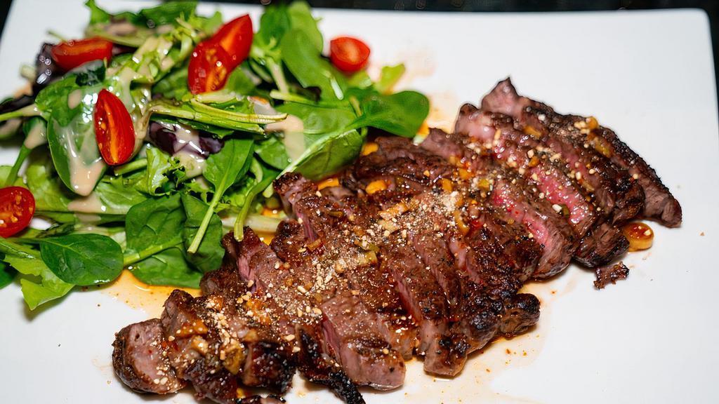 Crying Tiger Steak · New York strip steak, salad, nam jim jaew.