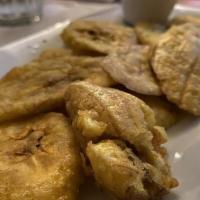 Tostones · Fried green plantains.