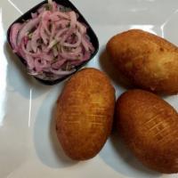 Papa Rellena · *Highly Recommended* Potato croquettes stuffed with beef, onions, and a hard boiled egg.