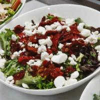 Crumbled Goat Cheese Salad · Organic mixed greens, baby arugula, crumbled goat cheese, sun-dried tomatoes, roasted red pe...