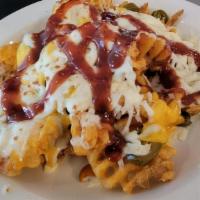 Potato Nachos · Crispy waffle fries topped with cheddar and mozzarella cheese, bacon, jalapeno peppers and b...