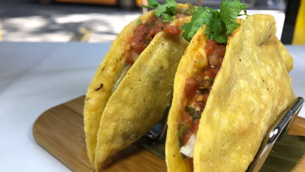 Hard Shell Tacos (2) · Folded crisp corn tortillas filled with shredded chicken, beef, or pork. Topped with cheese, lettuce & salsa Roja. Gluten-Free.