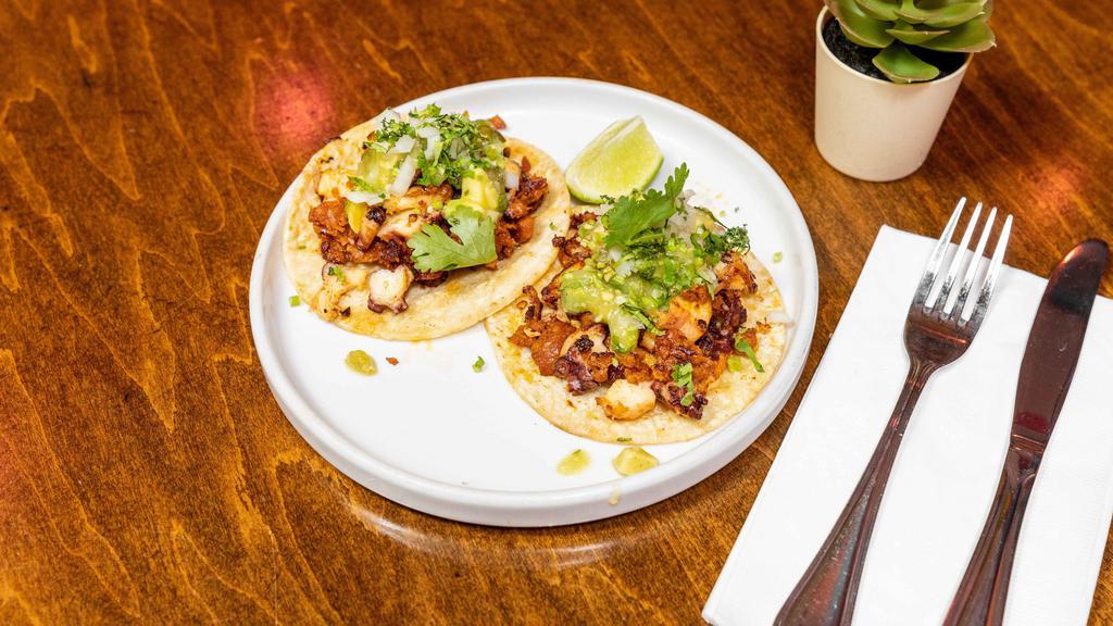 Tacos De Pulpo · Sauteed Octopus & Mexican chorizo served with tomatillo and avocado salsa and sprinkled w/onions & cilantro.
