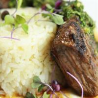 Carne Asada · 8 oz. skirt steak marinated with Mexican spices, served with white rice & black beans. Toppe...