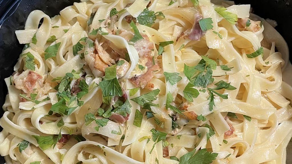 Fettuccine Carbonara · Homemade egg noodles sautéed with Italian bacon, onions, and olive oil in a delicate bechamel sauce..