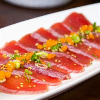 Tuna Tartarki · Thin sliced seared tuna served on top of cucumber and ponzu sauce.