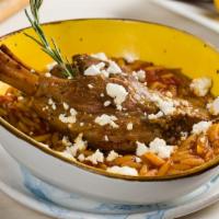 Arni Giouvetsi · Baby lamb oven baked in a clay pot with orzo, fresh tomato sauce, and feta cheese.
