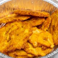 Tostones · Plantains that have been smashed and fried.