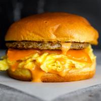 Brioche, Sausage, Egg, & Cheddar · 2 scrambled eggs, melted Cheddar cheese, breakfast sausage, and Sriracha aioli on a warm bri...