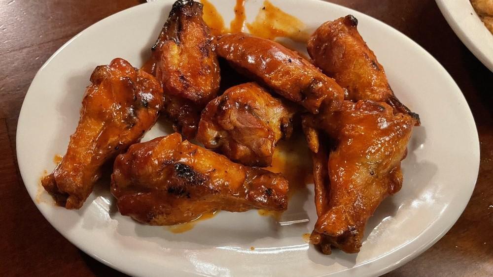 Chicken Wings · On the bone tossed in our barbecue or spicy buffalo sauce.