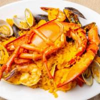 Seafood Paella Combination · With rice and lobster.