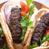 Kofta Pita · Ground meat blended with our special herb mix with lettuce, tomatoes, onions &. pickles driz...