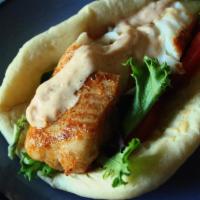 Salmon Pita · Lettuce, tomatoes, red onions, shredded cabbage. & sesame seed tahini garlic sauce.