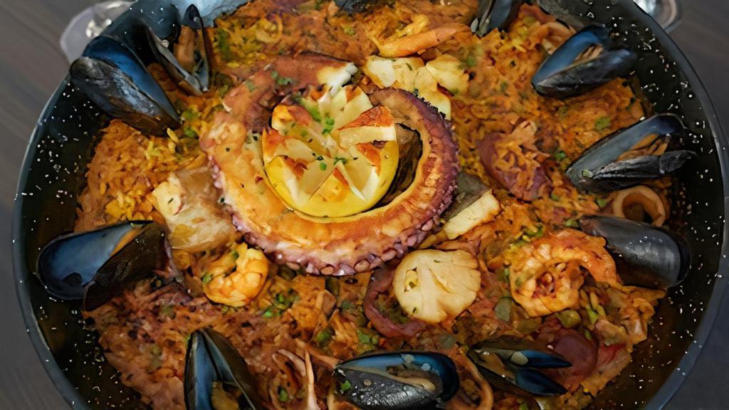 Paella Del Mar (For 2) · House signature. Prawns, scallops, octopus, shrimp, striped bass, mussels, squid, chorizo in saffron & lobster broth