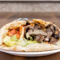 Lamb Shawarma Wrap · thinly sliced lamb off our shawarma donor, wrapped in our freshly made naan, with lettuce, t...