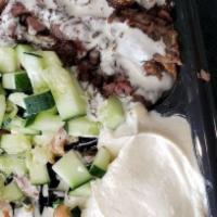 Lamb Shawarma Platter · Thinly sliced lamb off our shawarma donor, served over rice or salad, with your choice of 3 ...