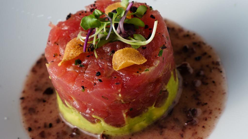 Tuna Tartare · Diced yellowfin tuna, avocado and crispy garlic with black olive dressing.