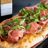 Carne Pizza · 18 inches long. Sopresatta, prosciutto, tomato, pepperoncini, and fresh mozzarella.