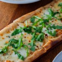 Quattro Formaggi Pizza · 18 inches long. Fontina, fresh mozzarella, gorgonzola, and scamorza.