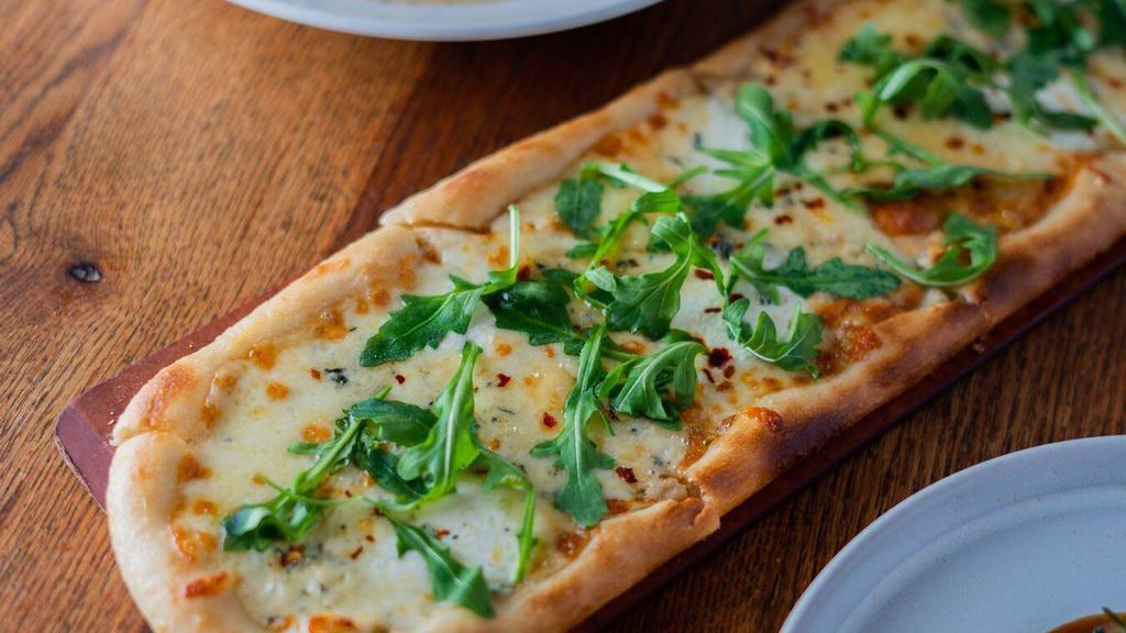 Quattro Formaggi Pizza · 18 inches long. Fontina, fresh mozzarella, gorgonzola, and scamorza.