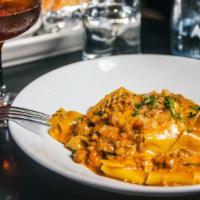 Pappardelle Bolognese · Ground veal, tomato and cream sauce.