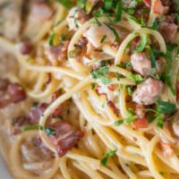 Spaghetti Carbonara · Pancetta, prosciutto, bacon, onions, and cream sauce.