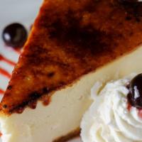 New York Style Cheesecake · Amarena cherries, whipped cream and brulee.