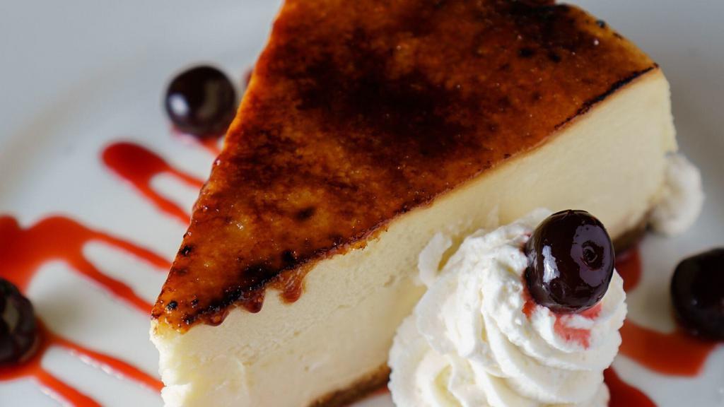New York Style Cheesecake · Amarena cherries, whipped cream and brulee.
