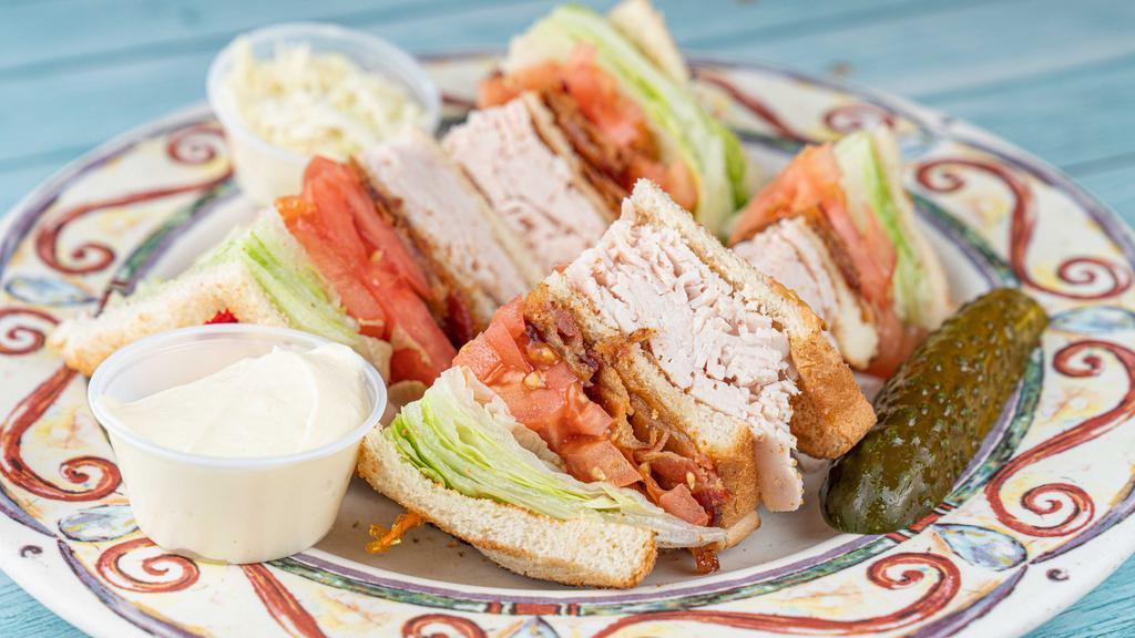 Turkey & Bacon Club Sandwich · All white meat. Served with coleslaw and pickle upon request.