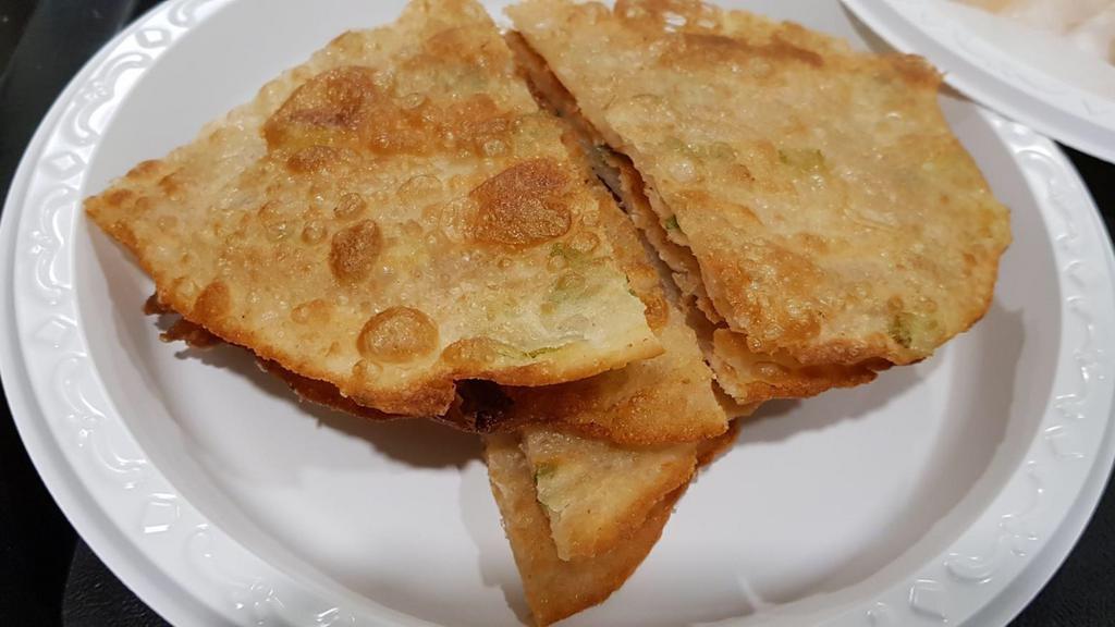 Scallion Pancakes · Savory unleavened flatbread folded with oil and minced scallions.