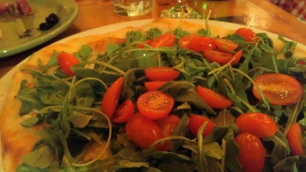Tricolore · Fresh mozzarella, Parmigiano, baby arugula, cherry tomatoes.