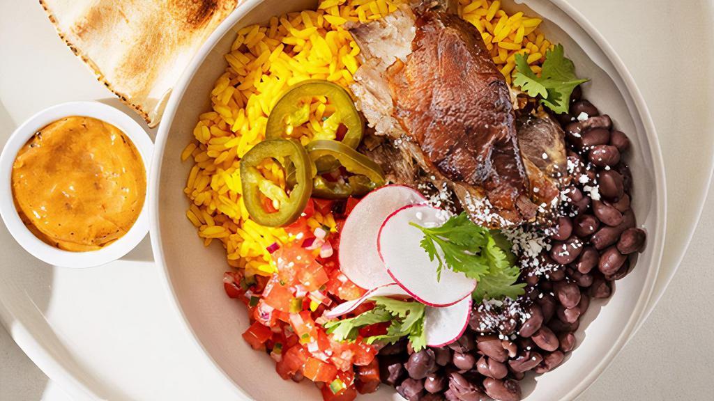 Slow Roasted Smoked Pork Bowl · tumeric rice, black beans, pickled jalapenos, tomato, pickled red onions, cotija, cilantro + chili whip