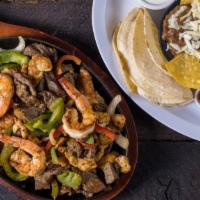 Fajitas Mixtas · Grilled chicken, beef , & shrimp served with bean, guacamole & tortillas
