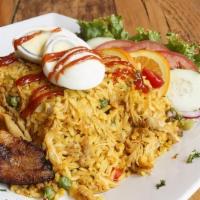 Arroz Con Pollo · Rice with shredded chicken & vegetables served with eggs & plantains
