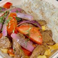 Lomo Saltado  (Best In Town) · marinated steak with sautéed red onions and tomatoes in our fiery wok, accompanied by fresh...
