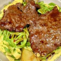 Tallarin Verde Con Bisteck · Our Palomilla steak placed on a bed of our own homemade Peruvian pesto sauced spaguetti with...