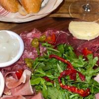 Charcuterie Board · An assortment of cured meats, pate de campagne served with cornichons, pearl onions, olives ...