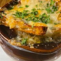 French Onion Soup · House made French Onion soup, with home made chicken stock, topped with Campagne and a melte...