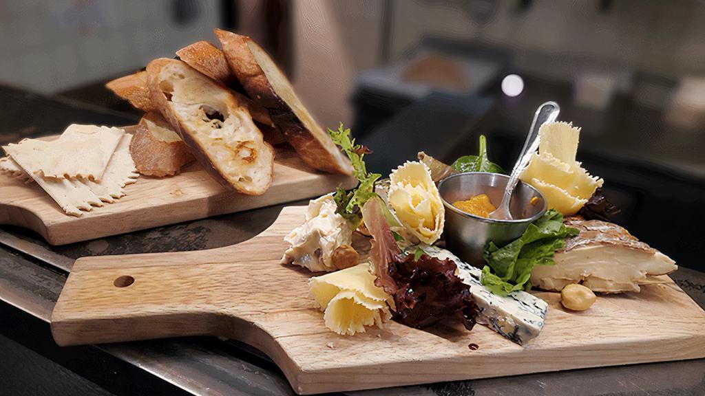 Cheese Plate · A variety of cheeses, including camembert, Gouda, herb goat cheese,, 24-month aged comte, Brillat Savarin Affiné, reblochon, Roquefort, served with fig jam