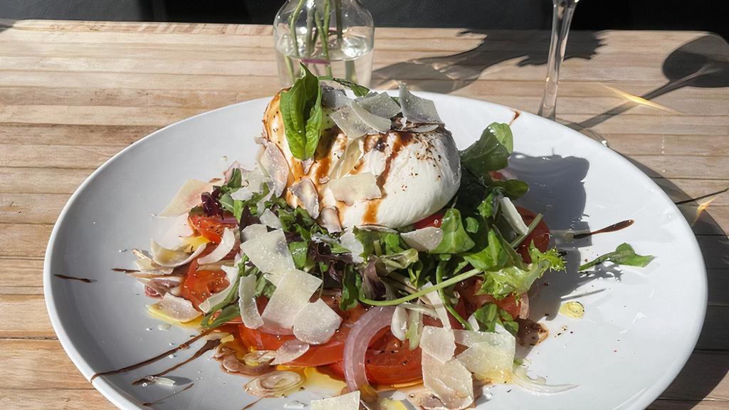 Burrata Caprese · Burrata served over mixed greens, basil and pine nuts with tomatoes, shallots, chives and drizzled with olive oil and balsamic vinegar