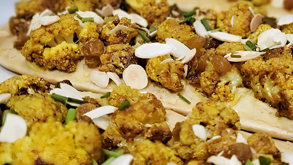 Cauliflower (Vegan) · Curry-roasted cauliflower, house-made hummus, golden raisins, toasted almonds, on toasted, non-dairy naan