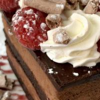 Flourless Chocolate Mousse Cake · Cocoa meringues, raspberry sauce, creme chantilly