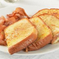Bacon French Toast · Sliced challah bread soaked eggs and milk, then fried and topped with crispy bacon served wi...
