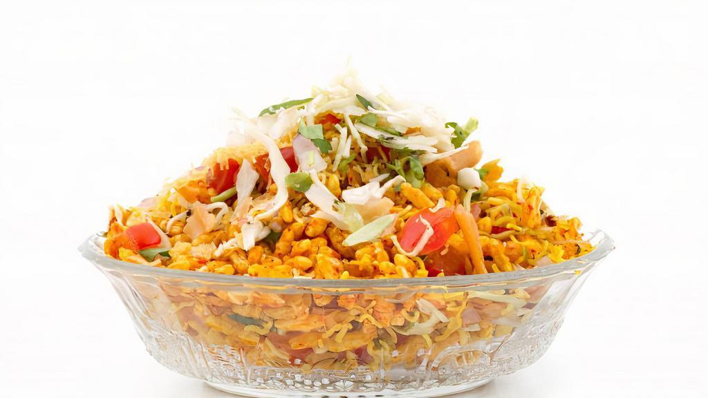 Bhel · Mix of rice puffs and savories, topped with spicy cilantro and mint chutney