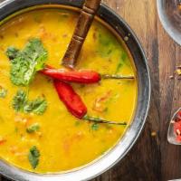 Dal Tadka · Yellow lentils sautéed with ginger, garlic, onions, tomatoes, red chili and spices.