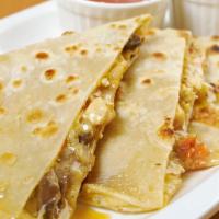 Steak Quesadilla · Juicy sliced steak, grilled peppers, onions, melty cheddar and jack cheese, served with sals...