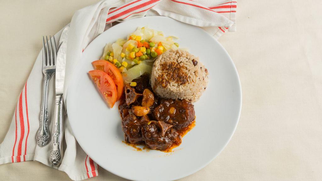 Oxtail · Served with choice of side and steam veggie.
