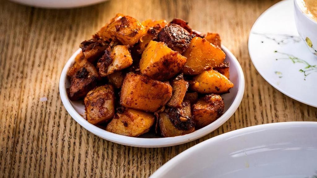Home Fries · Yukon gold potatoes cooked with the skin in oil, with green and red bell peppers, onion and seasoned with smoked paprika.