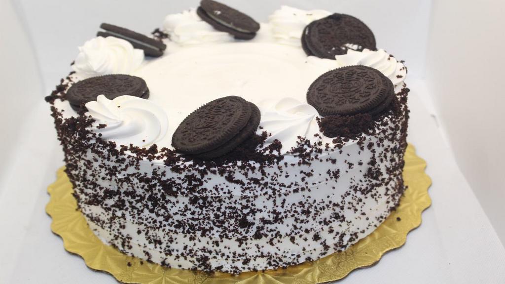 Chocolate Oreo Cake · Chocolate Cake w/ Oreo Filling and Whipped Cream Icing and Oreo Cookies ontop.