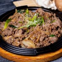Bulgogi (Korean Bbq Beef) / 철판 불고기 · Grilled Marinate thin sliced rib eye with onions, scallions, and mushrooms.